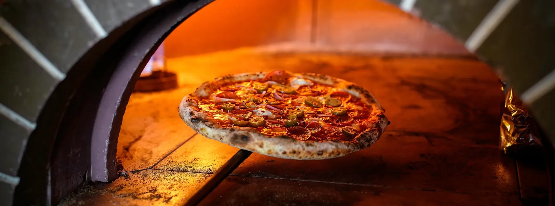 Unsere handgemachte Pizza, frisch aus dem Steinofen